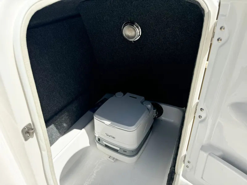 Slide: The Image of Interior of 2024 NauticStar 223 DC with portable toilet. - 7