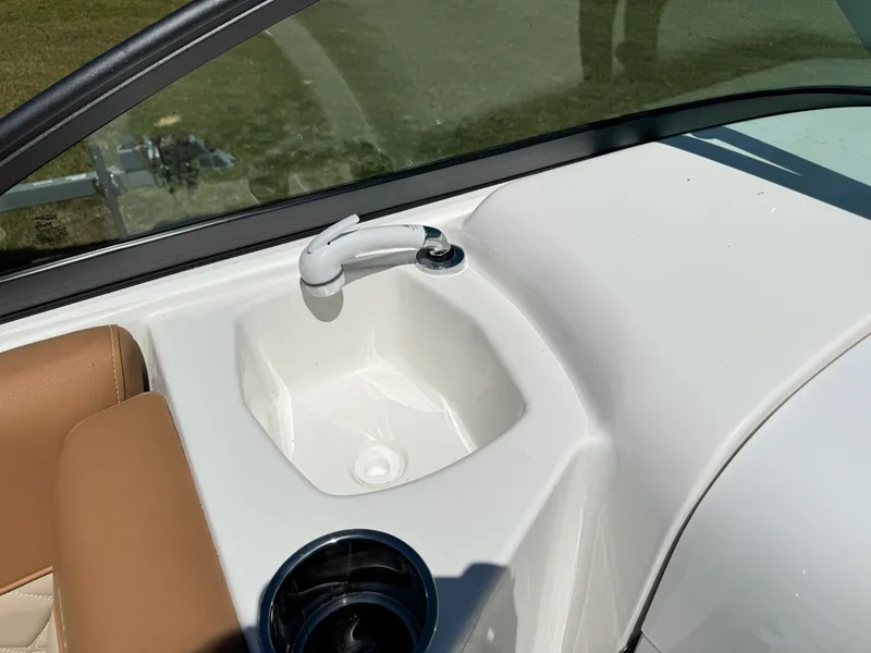 Slide: The Image of NauticStar 223 DC 2024 featuring built-in sink and faucet. - 8