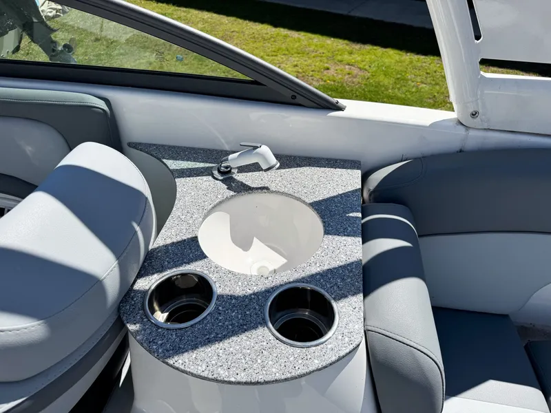 Slide: The Image of Interior of 2023 NauticStar 243 DC with sink and cup holders. - 11