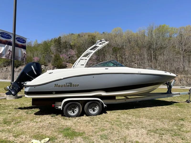 Slide: The Image of 2023 NauticStar 243 DC boat on trailer outdoors. - 3