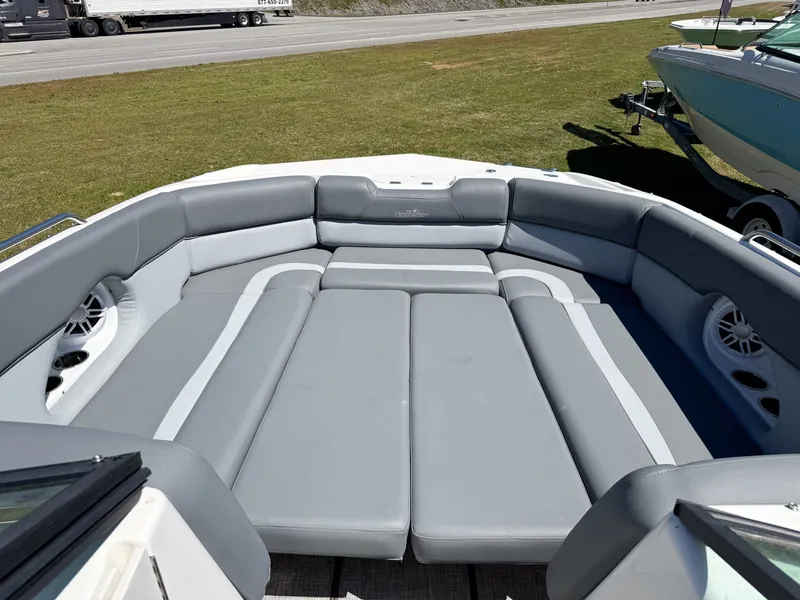 Slide: The Image of 2023 NauticStar 243 DC boat with gray upholstery outdoors. - 5