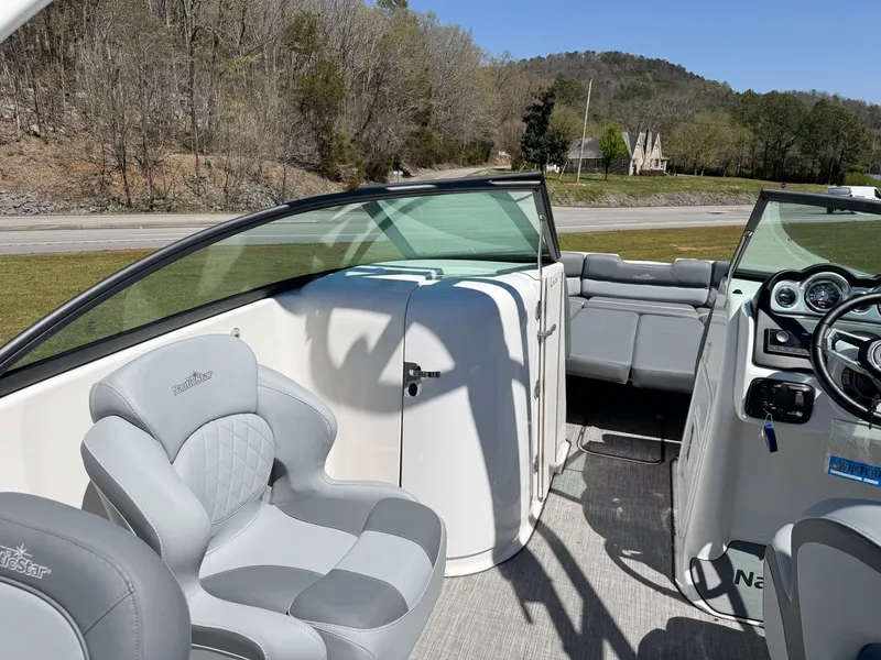 Slide: The Image of Interior of 2023 NauticStar 243 DC with gray seating and dashboard. - 8