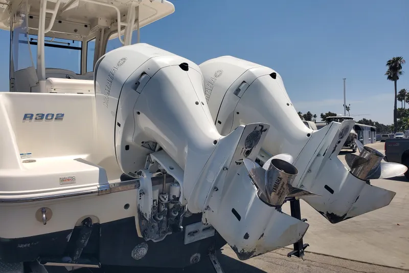 Slide: The Image of 2017 Robalo R302 Center Console boat with dual Yamaha outboard engines. - 10