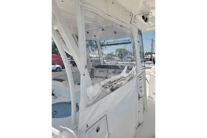 Slide: The Image of 2017 Robalo R302 Center Console boat with clear enclosure and visible interior details. - 12