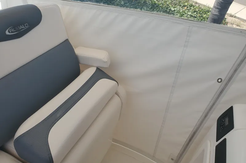 Slide: The Image of 2017 Robalo R302 Center Console boat seat with armrest and control panel. - 13