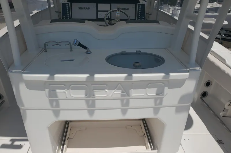 Slide: The Image of 2017 Robalo R302 Center Console boat interior with sink and storage. - 15