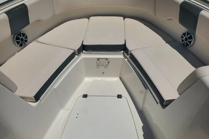 Slide: The Image of 2017 Robalo R302 Center Console boat interior with cushioned seating and speakers. - 17