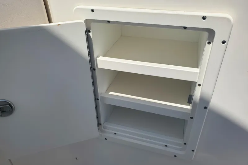 Slide: The Image of Open storage compartment on 2017 Robalo R302 Center Console boat. - 18