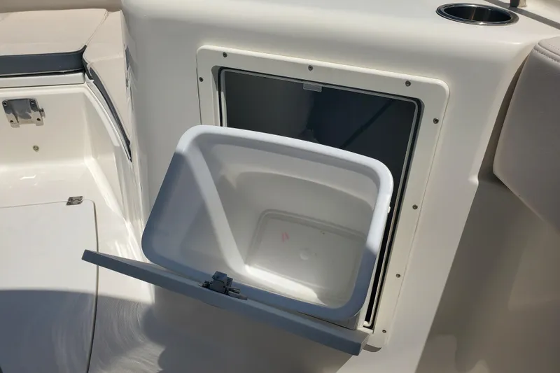 Slide: The Image of 2017 Robalo R302 Center Console boat with open storage compartment. - 19