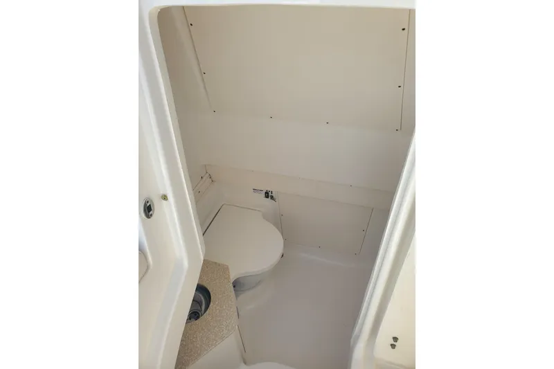 Slide: The Image of 2017 Robalo R302 Center Console boat interior with compact bathroom. - 21