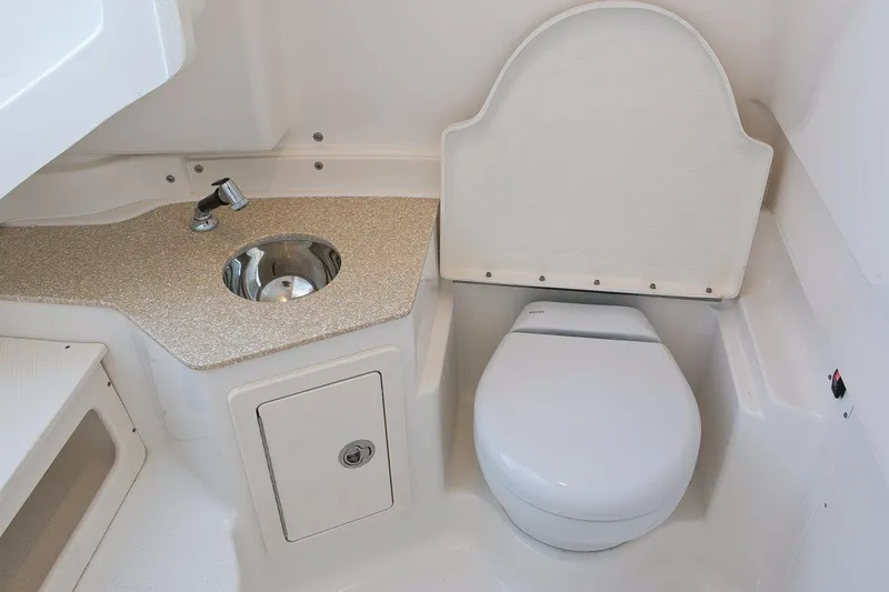 Slide: The Image of Manufacturer Provided Image: 2017 Robalo R302 Center Console boat bathroom with sink and toilet. - 22