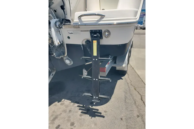 Slide: The Image of 2017 Robalo R302 Center Console boat with a metal boarding ladder attached. - 23