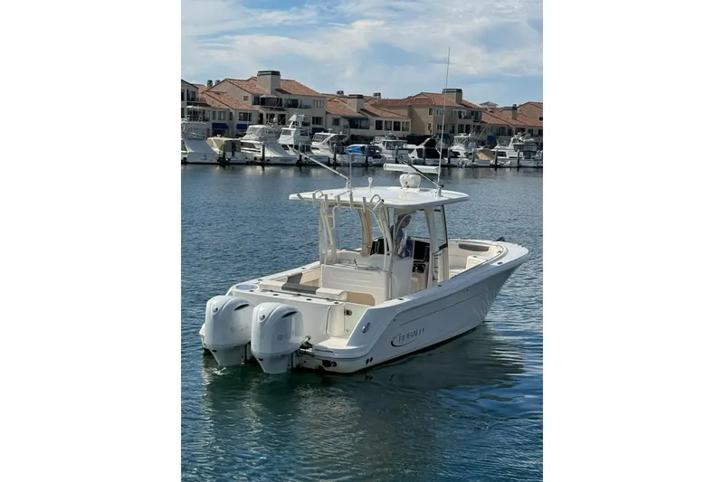 Slide: The Image of 2017 Robalo R302 Center Console boat docked in a marina with other vessels. - 8