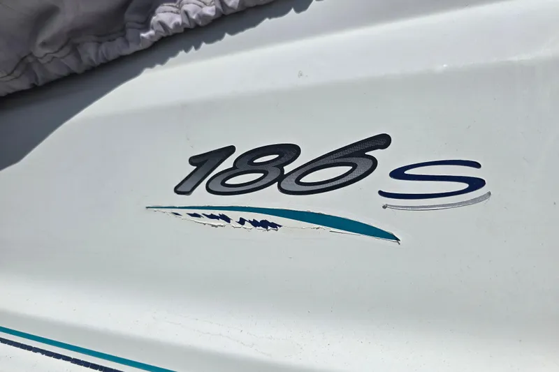 Slide: The Image of Close-up of 1999 Wellcraft 186 SS/S boat model emblem on white surface. - 14