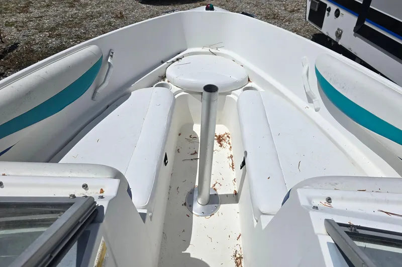 Slide: The Image of Interior view of a 1999 Wellcraft 186 SS/S boat with white seating and teal accents. - 15