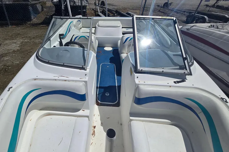 Slide: The Image of 1999 Wellcraft 186 SS/S boat interior with blue and white seating, open windshield. - 16