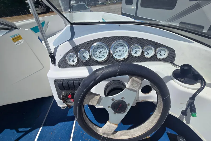Slide: The Image of 1999 Wellcraft 186 SS/S boat dashboard with steering wheel and gauges. - 21