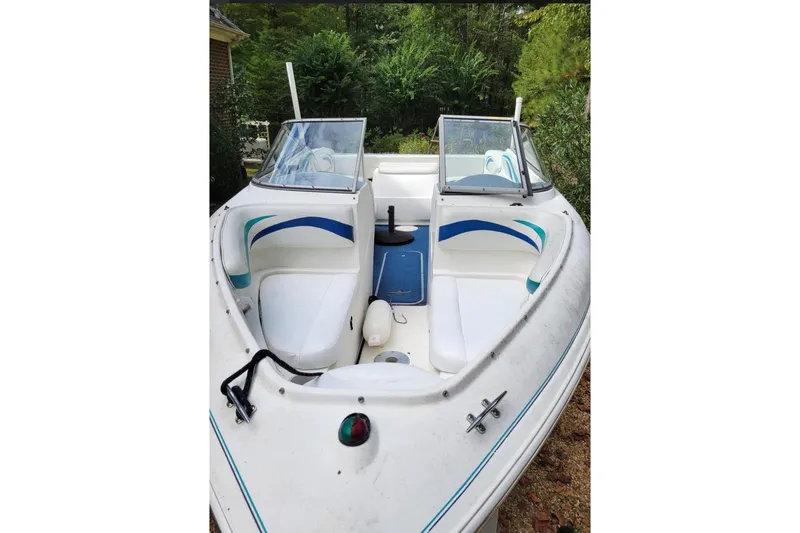 Slide: The Image of 1999 Wellcraft 186 SS/S boat with white and blue interior, docked outdoors. - 27