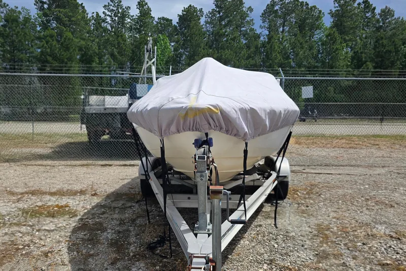 Slide: The Image of Covered 1999 Wellcraft 186 SS/S boat on trailer, parked outdoors near a fence. - 7