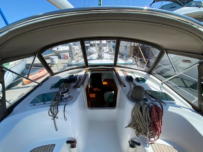 Slide: The Image of Cockpit view of a 2003 Beneteau 423 sailboat docked at a marina. - 15