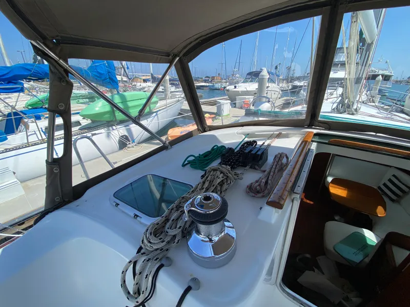 Slide: The Image of Cockpit view of a 2003 Beneteau 423 sailboat docked at a marina. - 16
