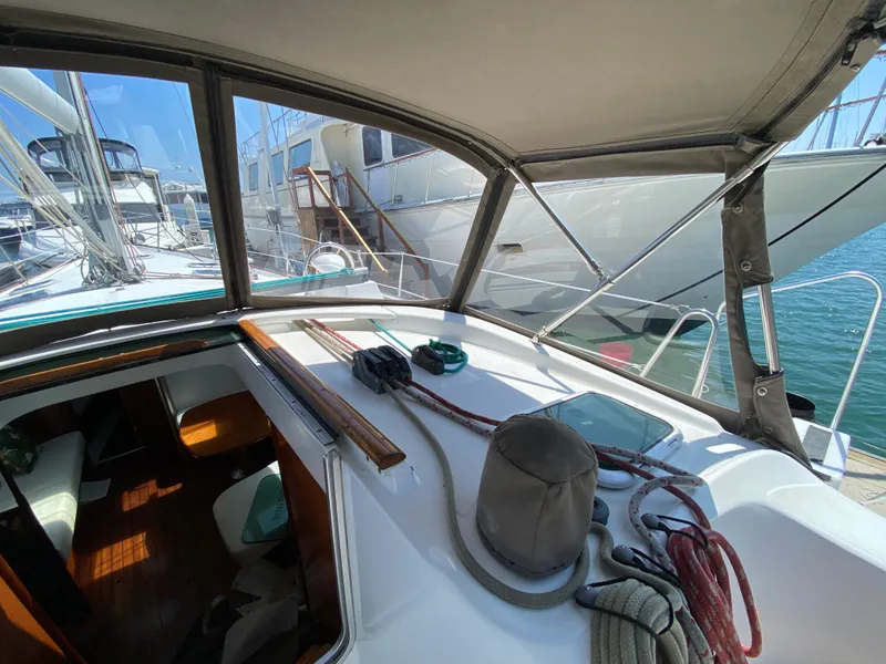 Slide: The Image of Cockpit view of a 2003 Beneteau 423 sailboat docked at a marina. - 17