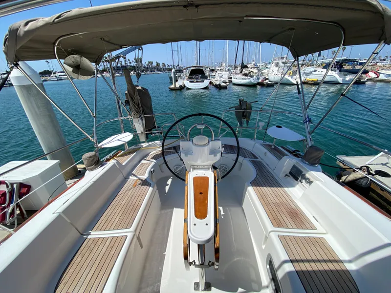 Slide: The Image of 2003 Beneteau 423 sailboat cockpit with steering wheel, docked at marina. - 18
