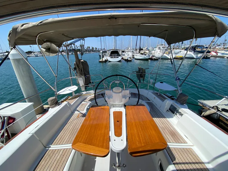 Slide: The Image of 2003 Beneteau 423 sailboat cockpit with wooden table, docked at marina. - 19