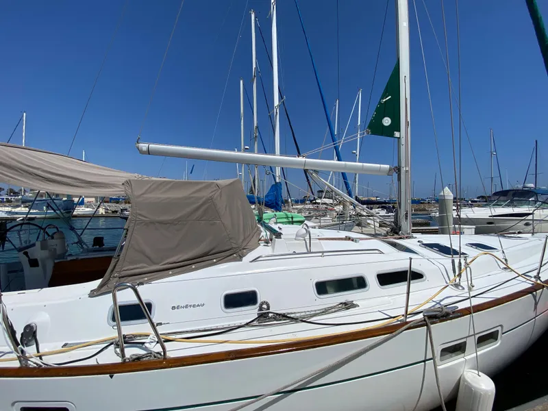 Slide: The Image of 2003 Beneteau 423 sailboat docked in a marina under a clear blue sky. - 2