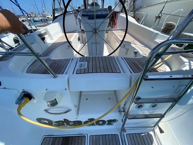 Slide: The Image of Cockpit of 2003 Beneteau 423 sailboat with teak decking and steering wheel. - 23