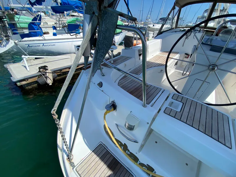Slide: The Image of Beneteau 423 sailboat, 2003 model, docked at marina with visible steering wheel and deck. - 25