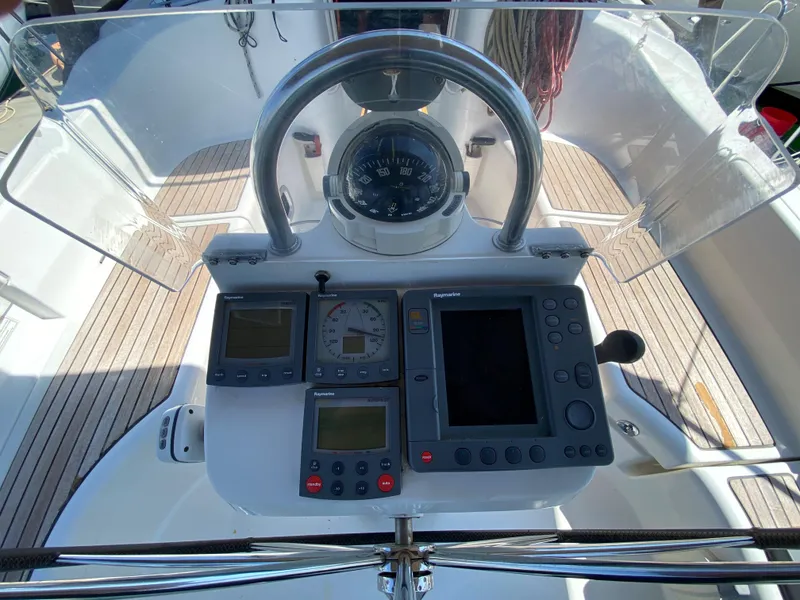 Slide: The Image of Beneteau 423 2003 sailboat cockpit with navigation instruments and steering wheel. - 27