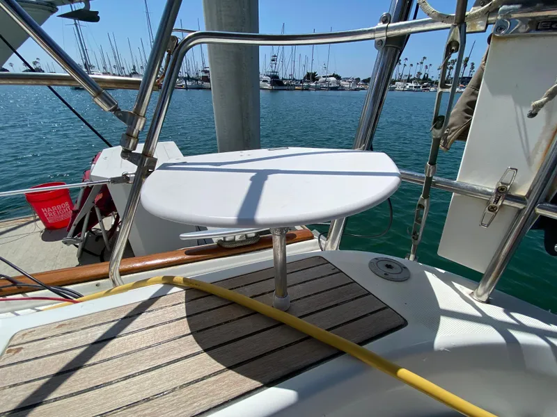 Slide: The Image of Beneteau 423 (2003) sailboat cockpit with table, docked at marina. - 28