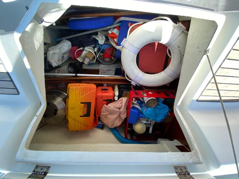 Slide: The Image of Storage compartment of a 2003 Beneteau 423 sailboat filled with various boating equipment. - 30