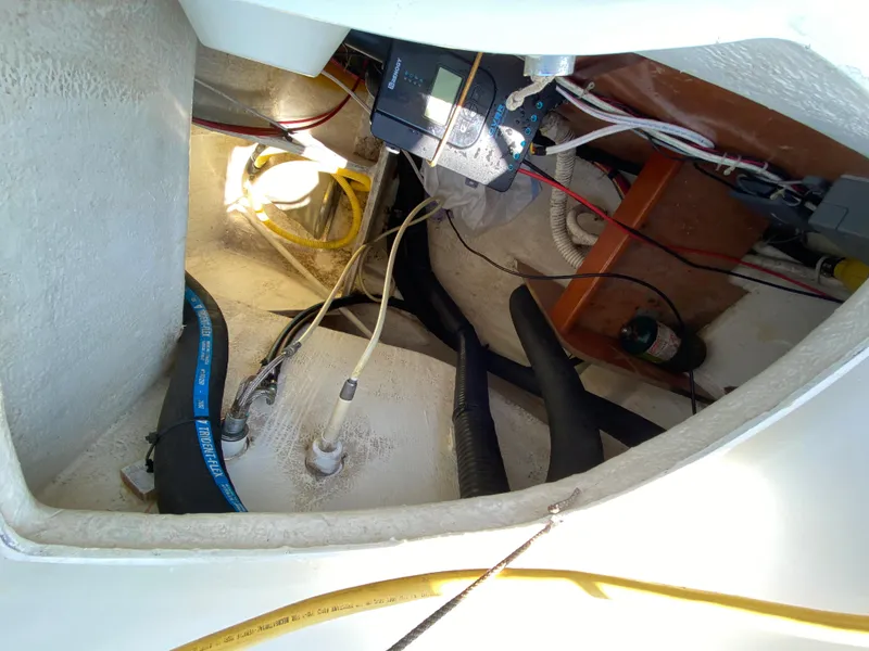 Slide: The Image of Engine compartment of a 2003 Beneteau 423 sailboat with visible wiring and hoses. - 31