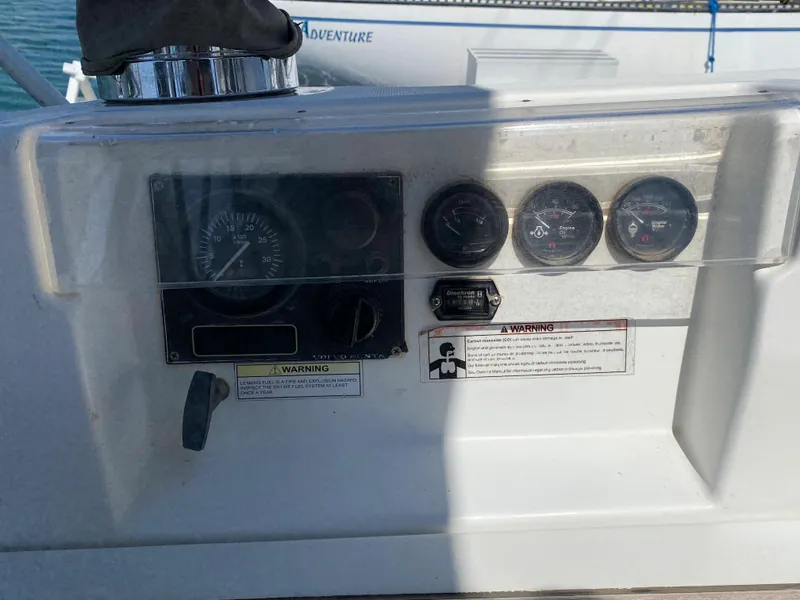 Slide: The Image of Control panel of a 2003 Beneteau 423 sailboat with gauges and warning labels. - 35