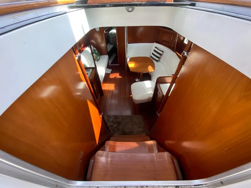 Slide: The Image of Interior of 2003 Beneteau 423 sailboat with wooden finishes and seating area. - 37