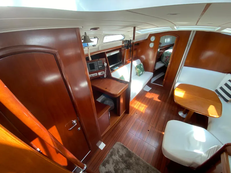 Slide: The Image of Interior of 2003 Beneteau 423 sailboat with wood finish and cozy seating area. - 38