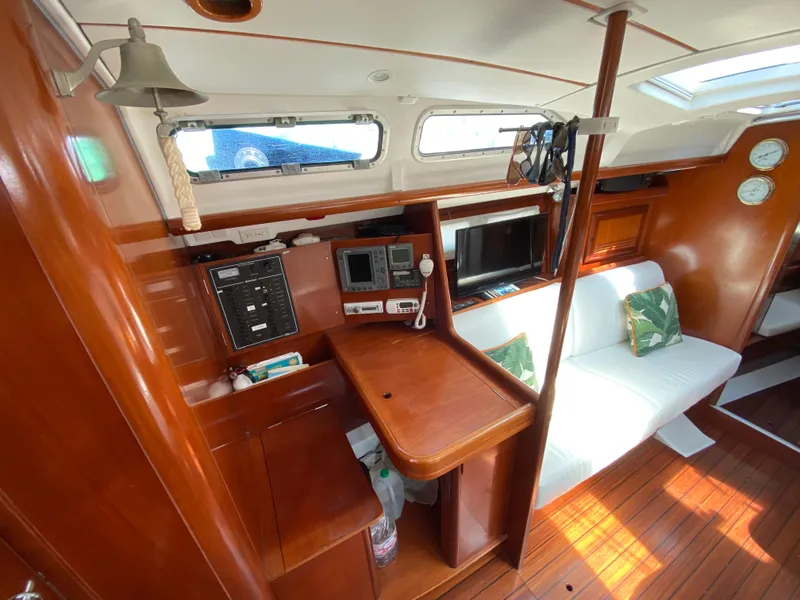 Slide: The Image of Interior of 2003 Beneteau 423 sailboat with wood finish and navigation equipment. - 45