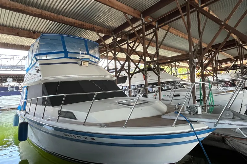 The Image of 1976 Fiberform 34 boat docked in a covered marina. - 0