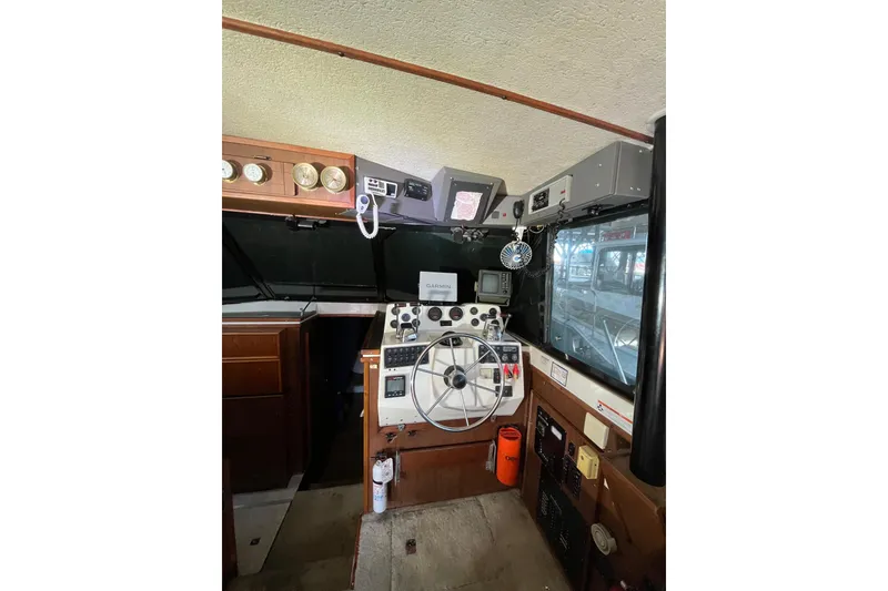 Slide: The Image of Interior of a 1976 Fiberform 34 boat cockpit with steering wheel and navigation equipment. - 10