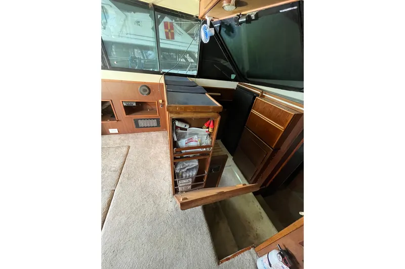 Slide: The Image of 1976 Fiberform 34 boat interior with wooden cabinetry and carpeted flooring. - 15