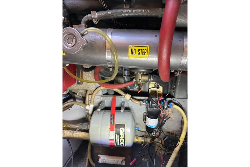 Slide: The Image of Engine compartment of a 1976 Fiberform 34 boat with visible hoses and components. - 16