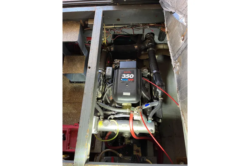 Slide: The Image of Engine compartment of a 1976 Fiberform 34 boat, featuring a MerCruiser 350 engine. - 17