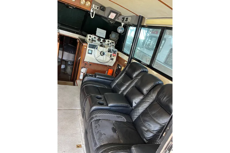 Slide: The Image of Interior of a 1976 Fiberform 34 boat with leather seating and navigation controls. - 19