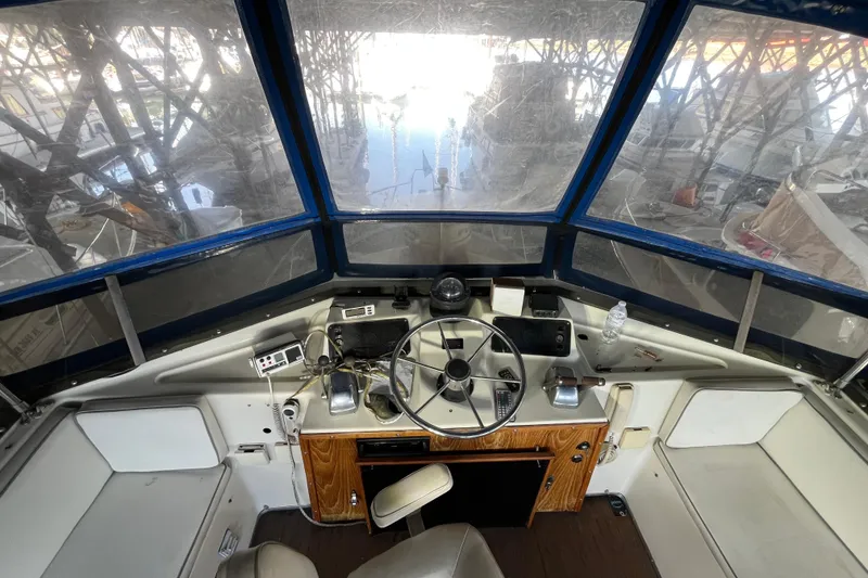 Slide: The Image of Interior view of a 1976 Fiberform 34 boat cockpit with steering wheel and controls. - 20