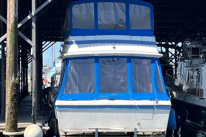 Slide: The Image of 1976 Fiberform 34 boat docked in a marina, featuring blue and white accents. - 23