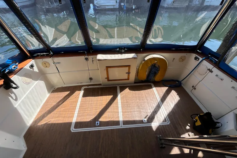 Slide: The Image of 1976 Fiberform 34 boat interior with wood flooring and waterfront view. - 4
