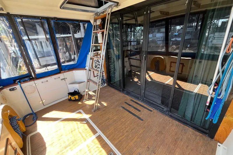 Slide: The Image of 1976 Fiberform 34 boat interior with wooden flooring, sliding glass doors, and nautical equipment. - 6