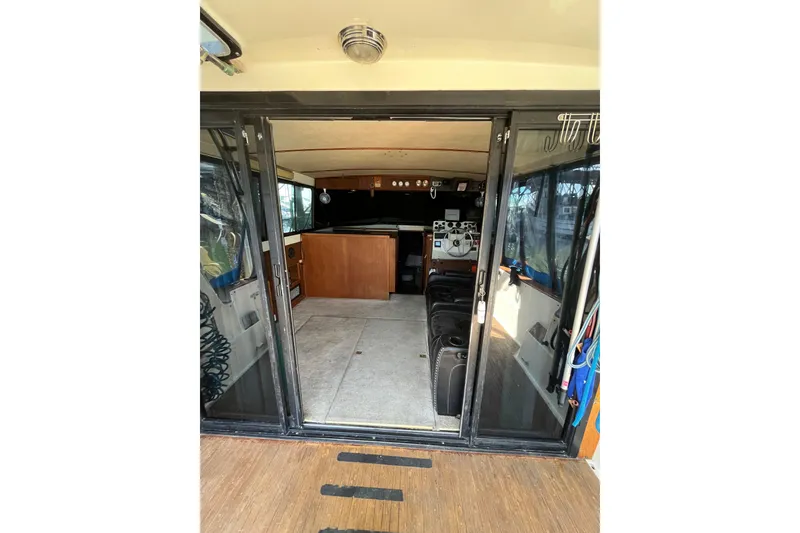 Slide: The Image of Interior view of a 1976 Fiberform 34 boat, showcasing cabin and seating area. - 7